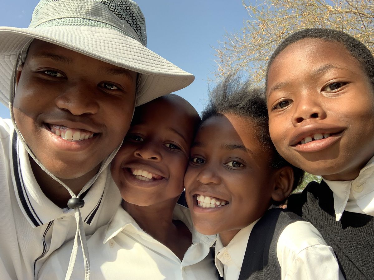 Motheo with children at Tlhabologo Primary School, Botswana